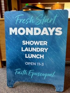 Sign at the parish hall for the Monday shower and laundry program